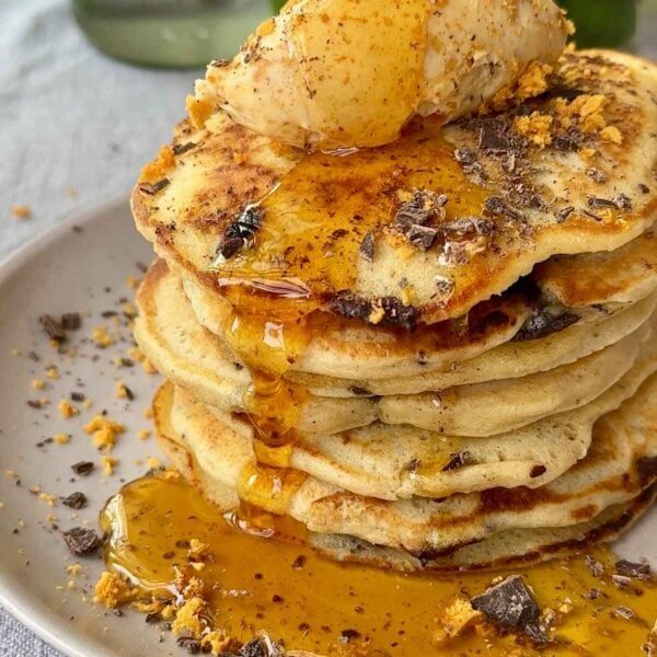 a stack of chocolate chip pancakes with syrup.