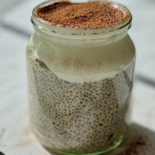 layered chia pudding with yogurt on top in a jar.