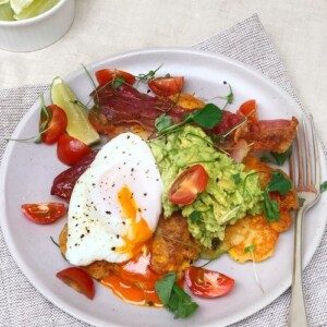 Sweetcorn fritters with avocado, cherry tomatoes and bacon.