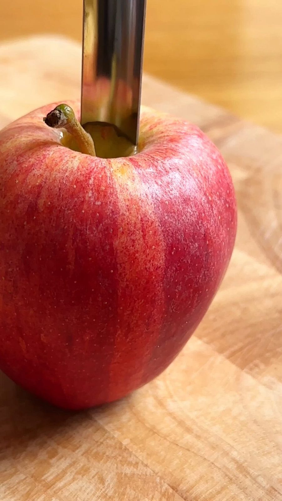 Coring a red apple.