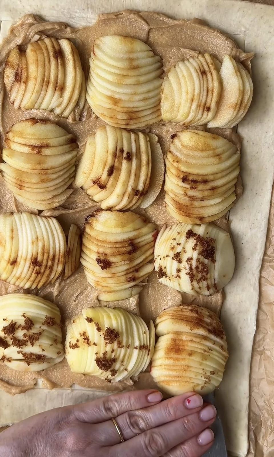 adding sliced apples to puff pastry.