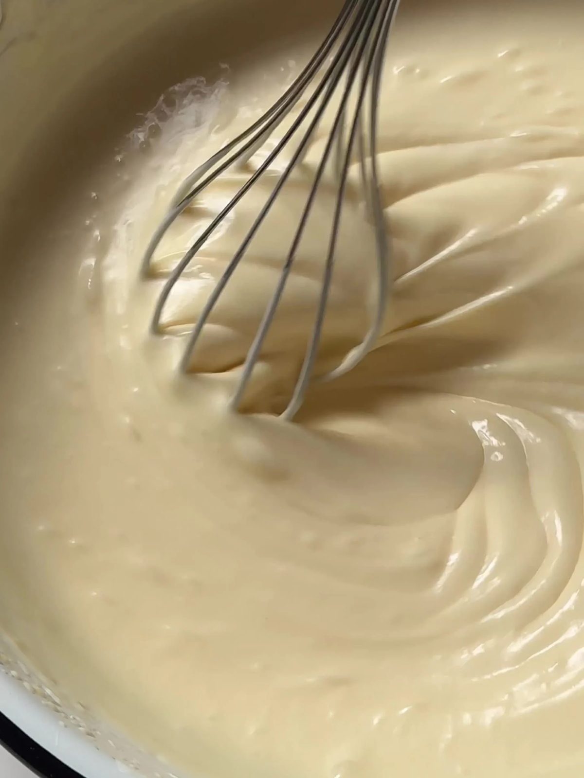 Whisking fritter batter with wire whisk.