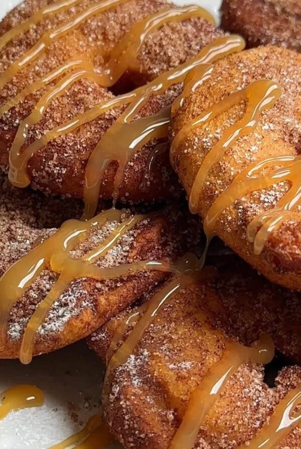 Appelflappen on a white plate with caramel sauce.