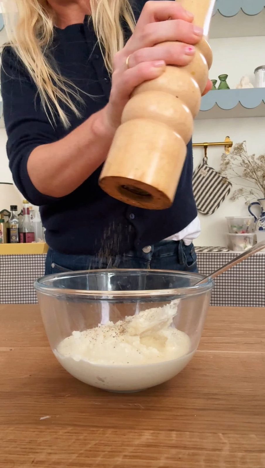 adding pepper to creamy topping.