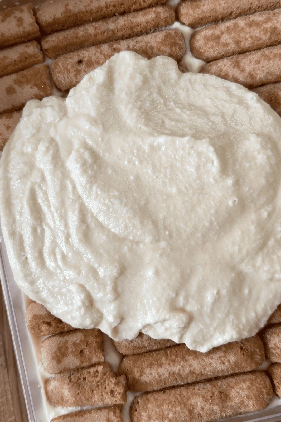 smoothing cream mixture on baileys tiramisu.