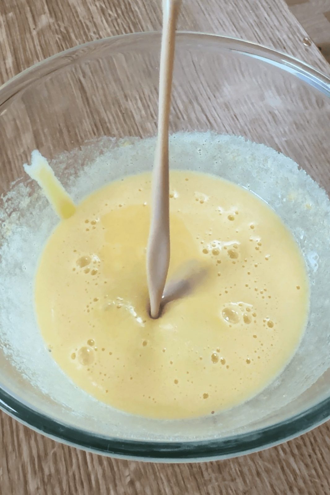adding baileys to egg yolks.