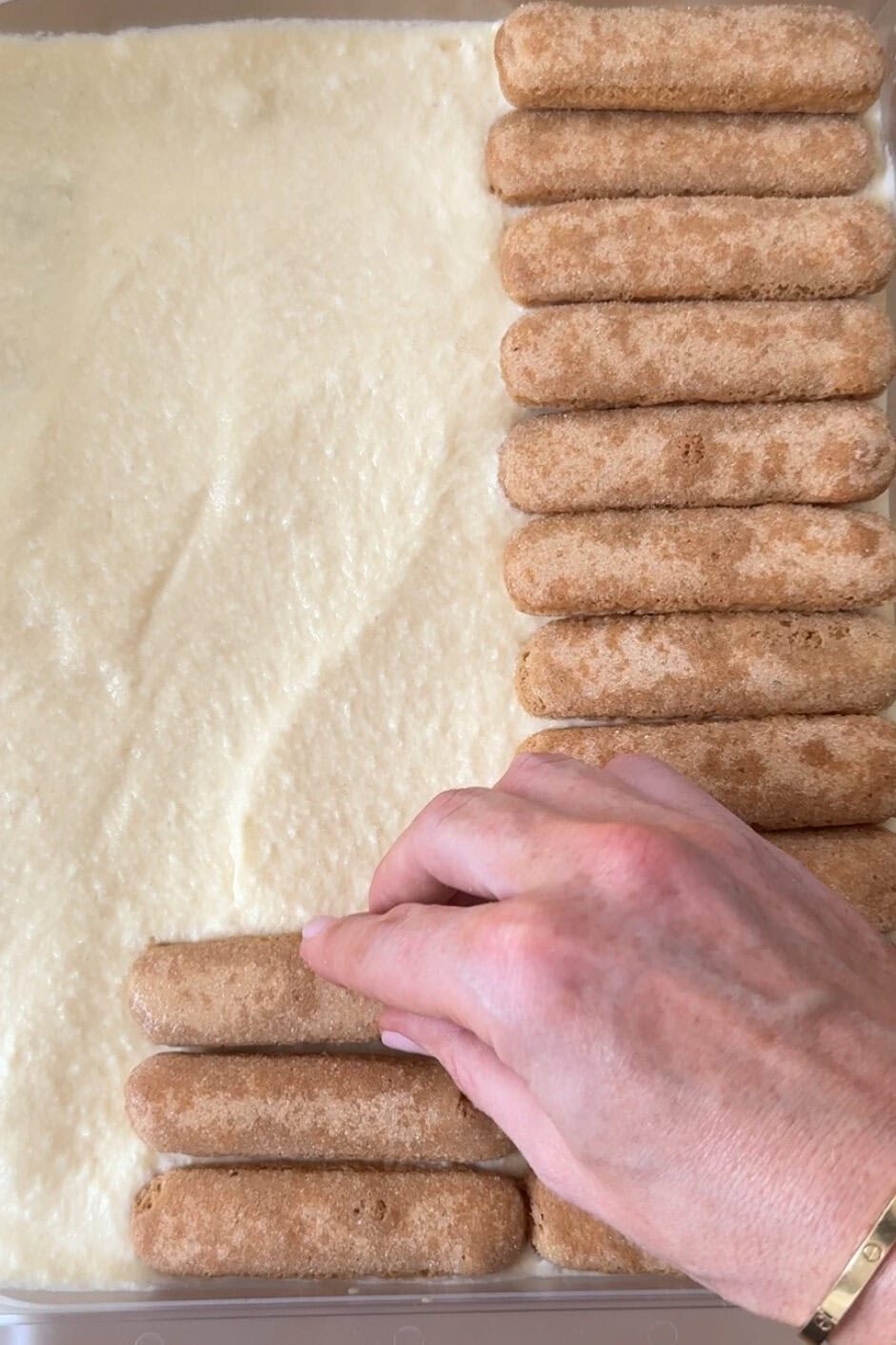 add soaked lady fingers to tiramisu.