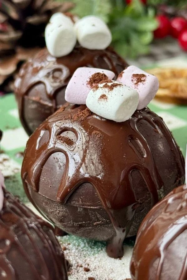 hot chocolate bomb on a plate with marshmallows on top.