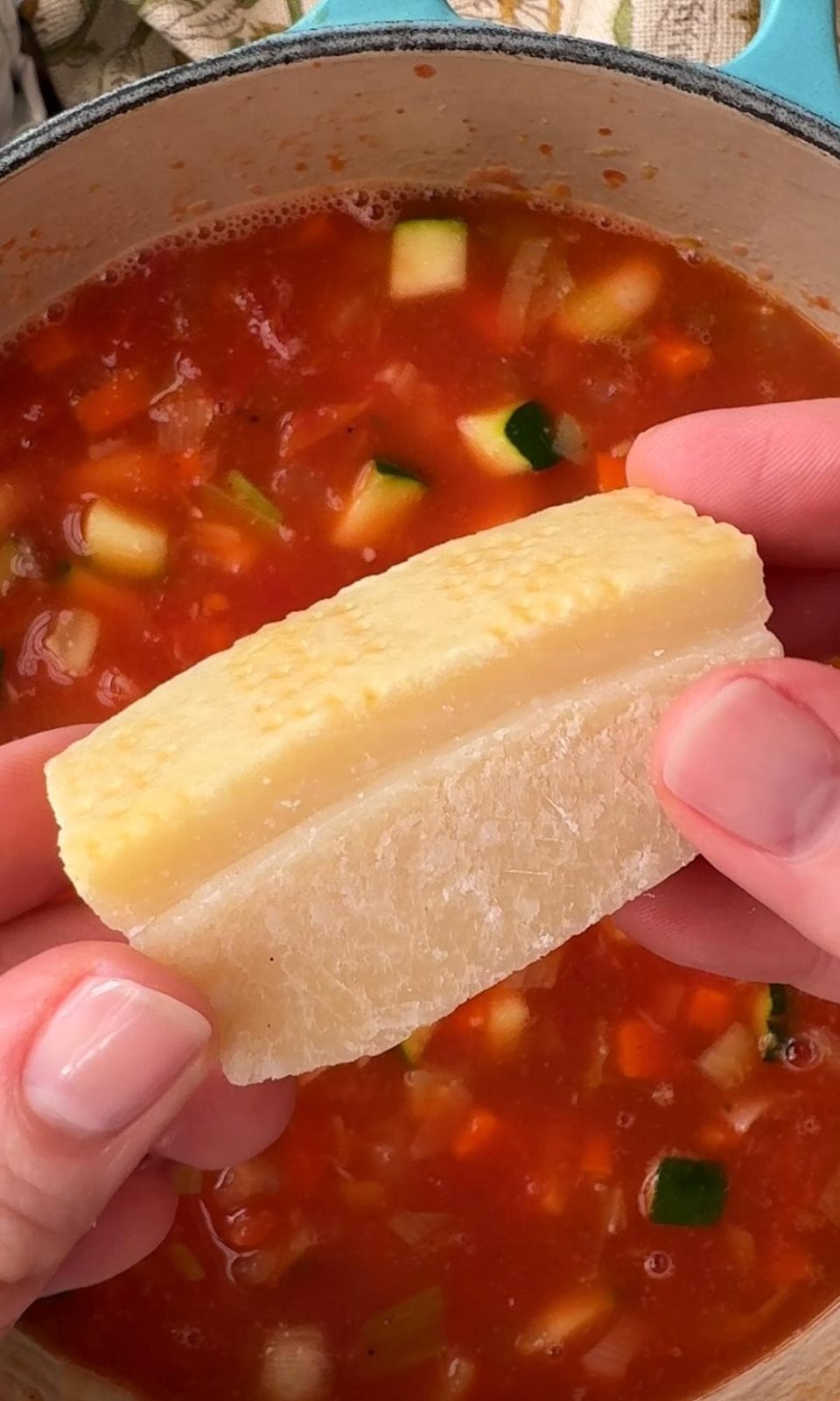 adding parmesan rind to bean stew.