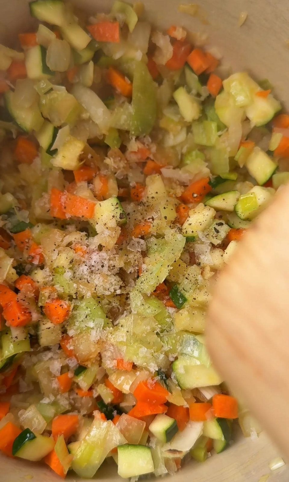 seasoning vegetables in the pan.
