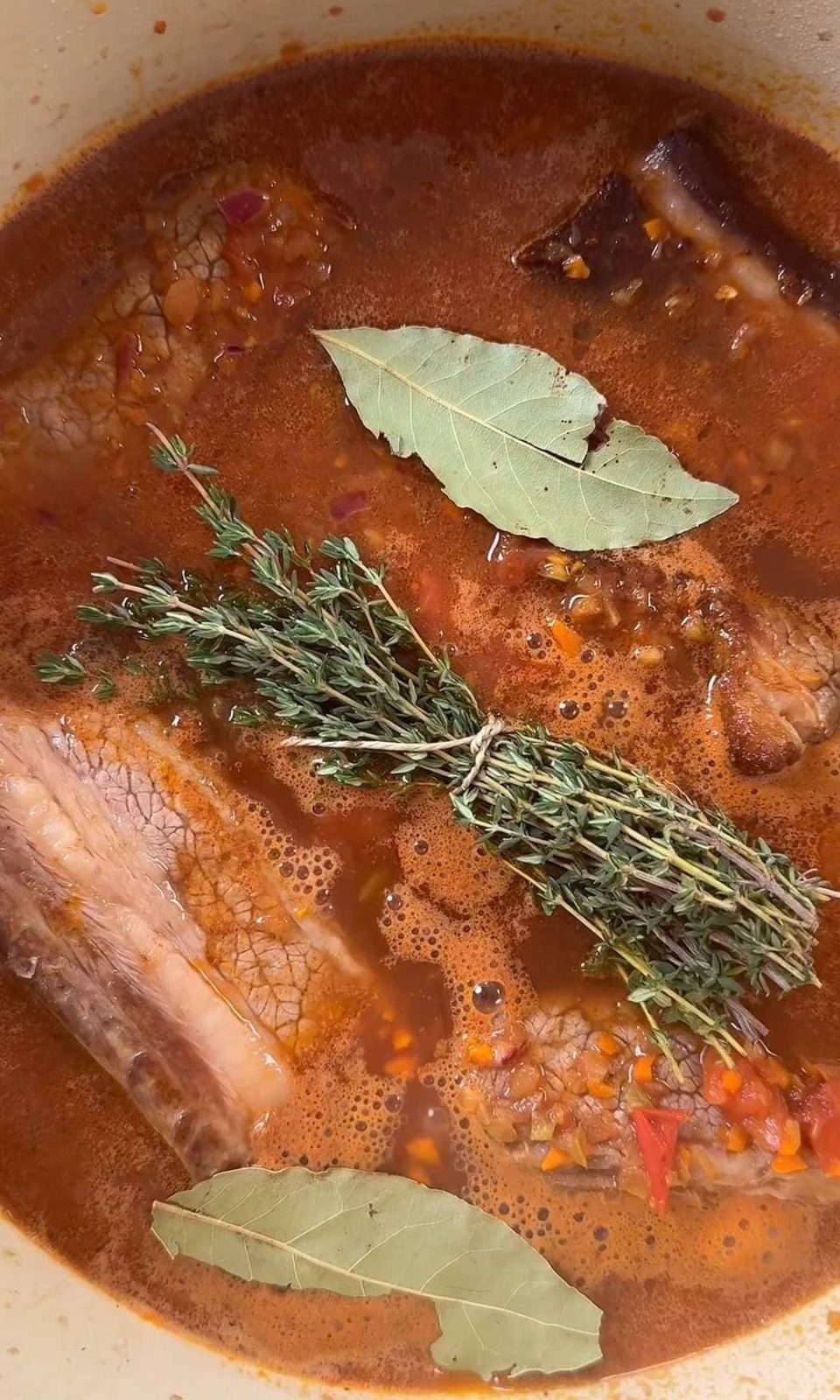 Beef short ribs ragu with thyme and bay leaves before braising.