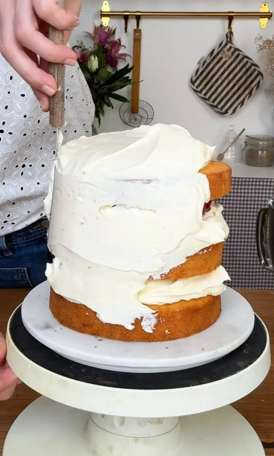 smoothing icing on berry cake.