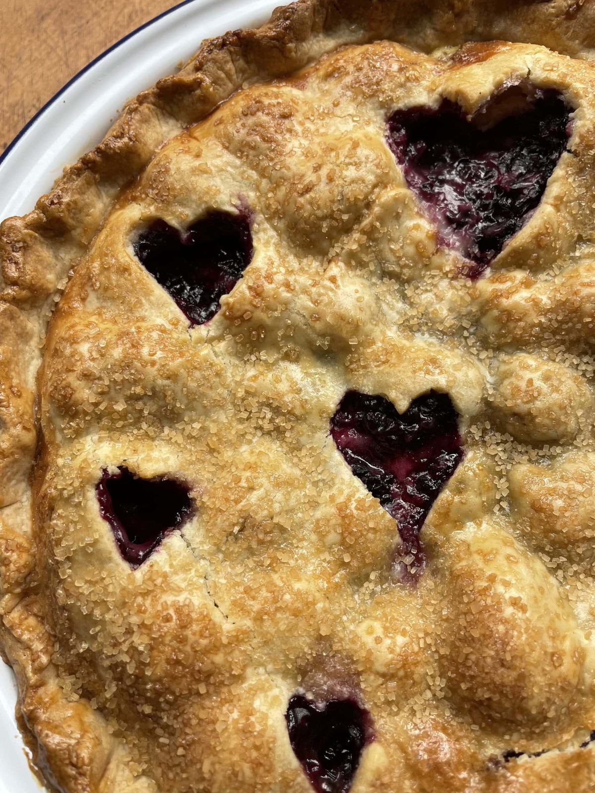 Blackberry pie with heart shapes cut into pastry.