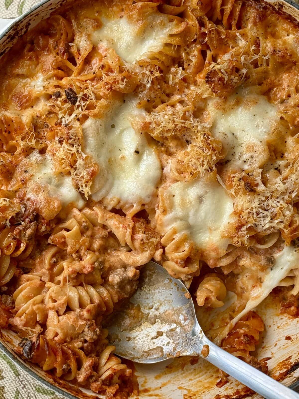 bolognese pasta bake with spoon,