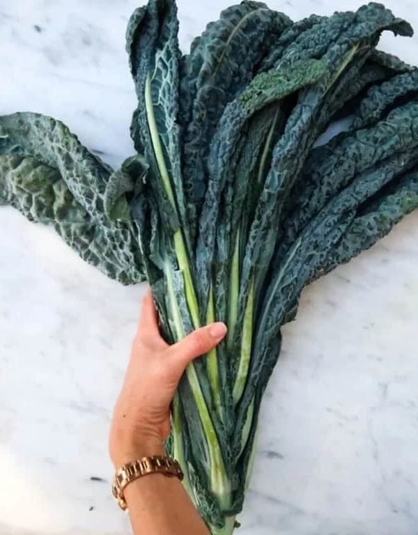 woman holding cavolo nero.