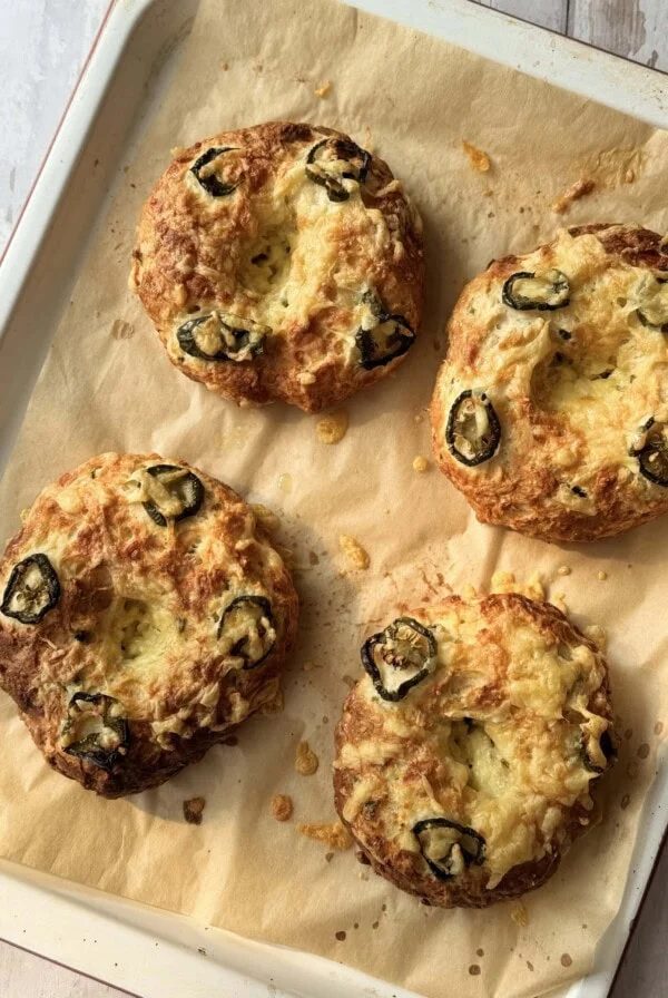 3 ingredient bagel with cheese and jalapeno on a tray.