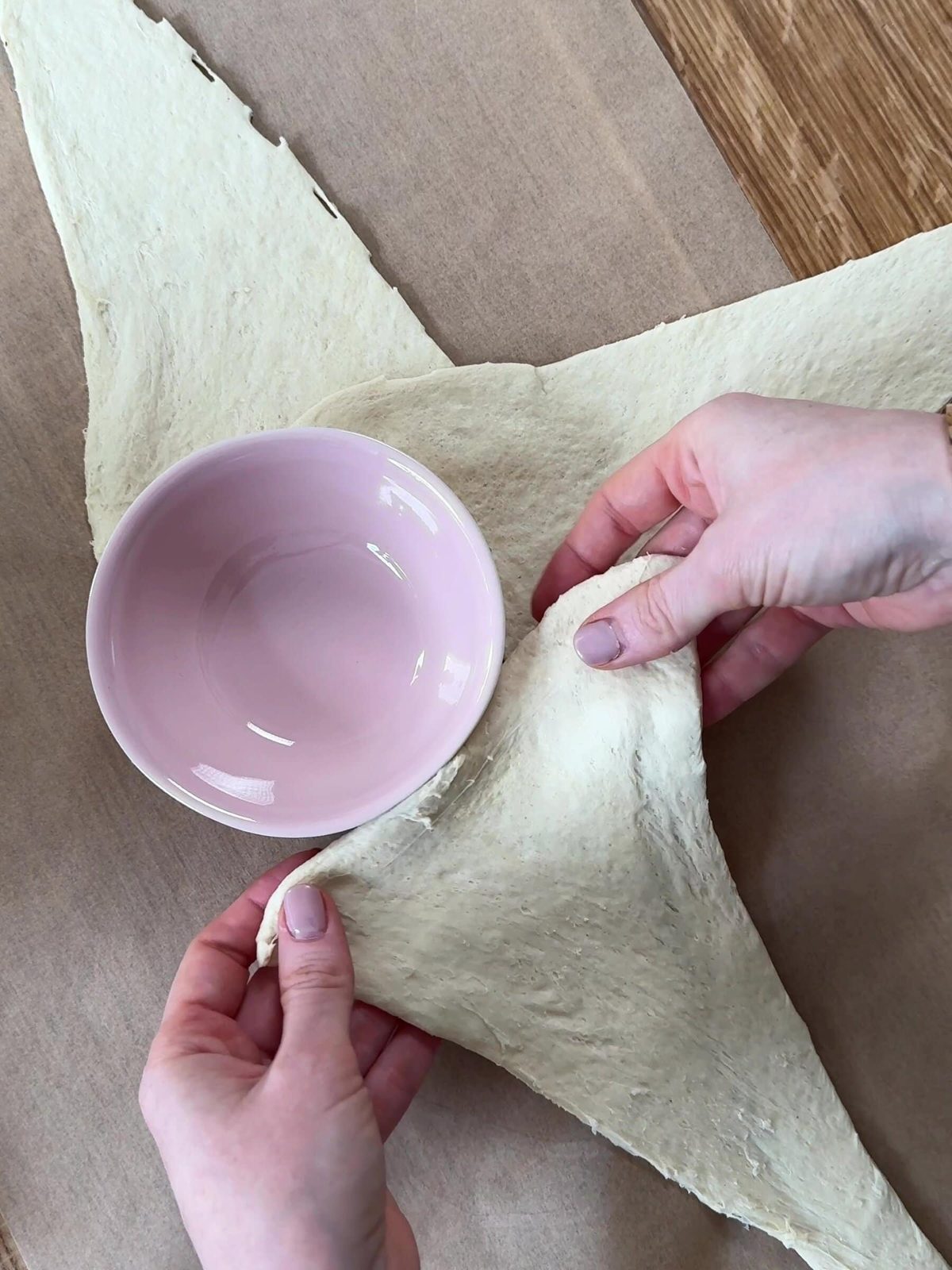 Placing croissant dough around the ramekin.