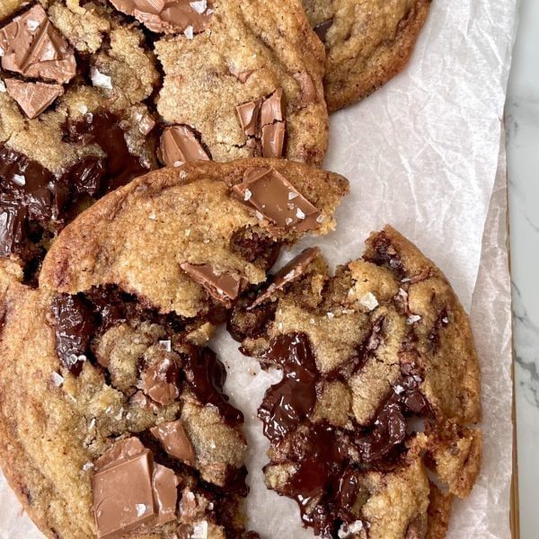 triple chocolate chunk cookies on parchment paper.