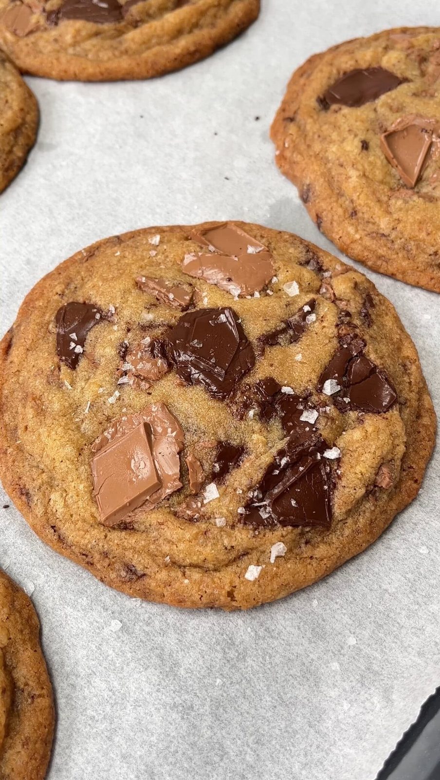 sprinkling the cookies with flakey salt.