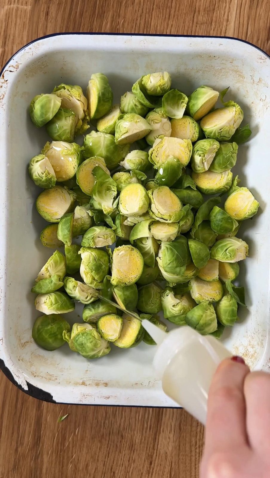 Drizzling Brussels sprouts with olive oil