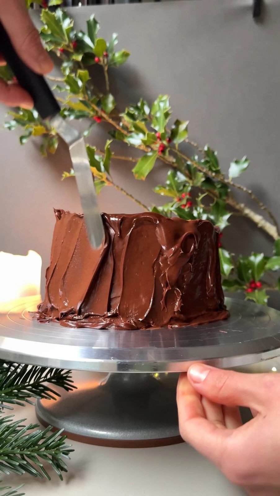 Decorating the buche de noel with chocolate ganache.