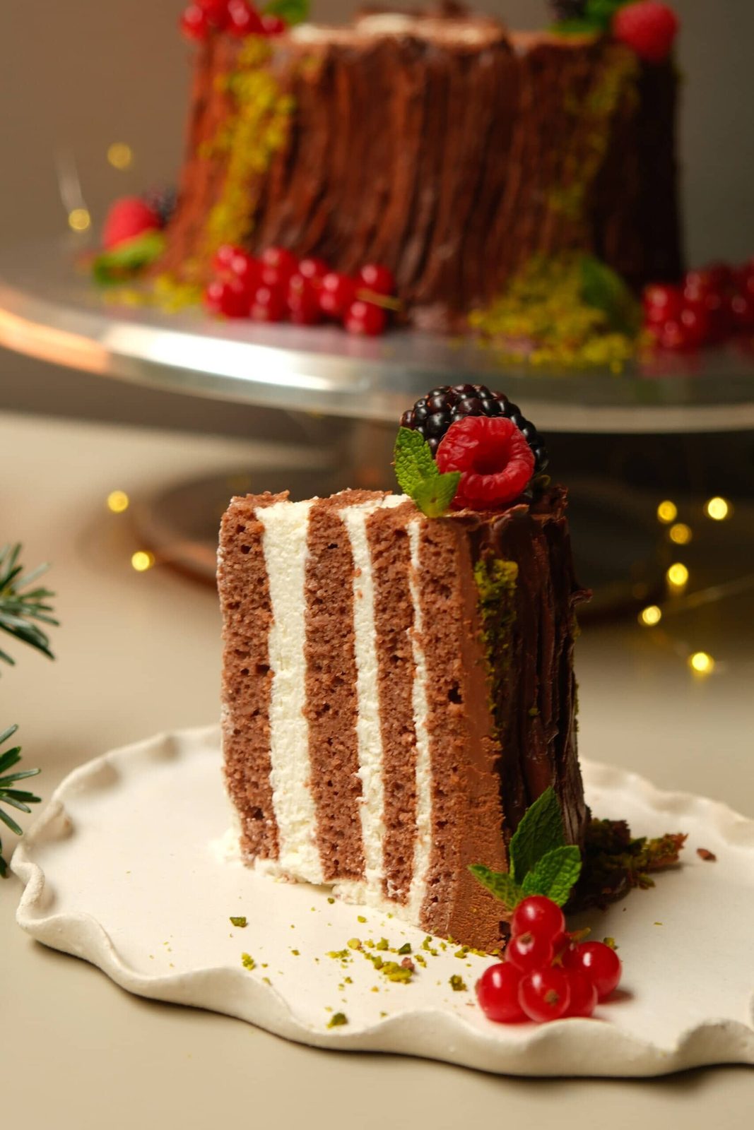 Sliced yule log on small festive plate.