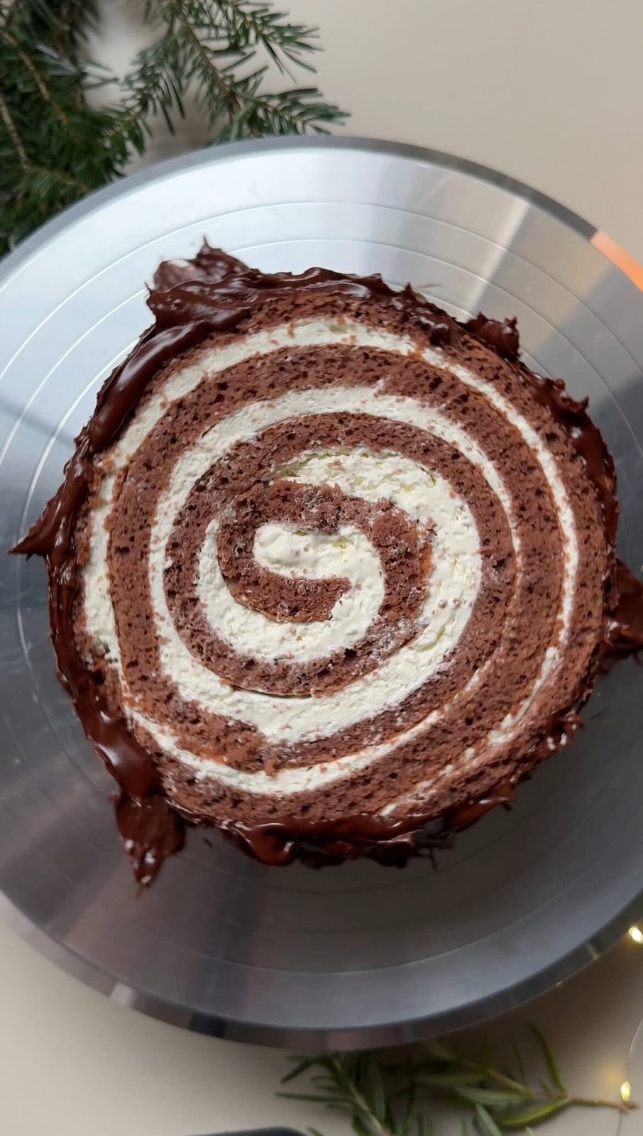Decorating yule log with ganache.