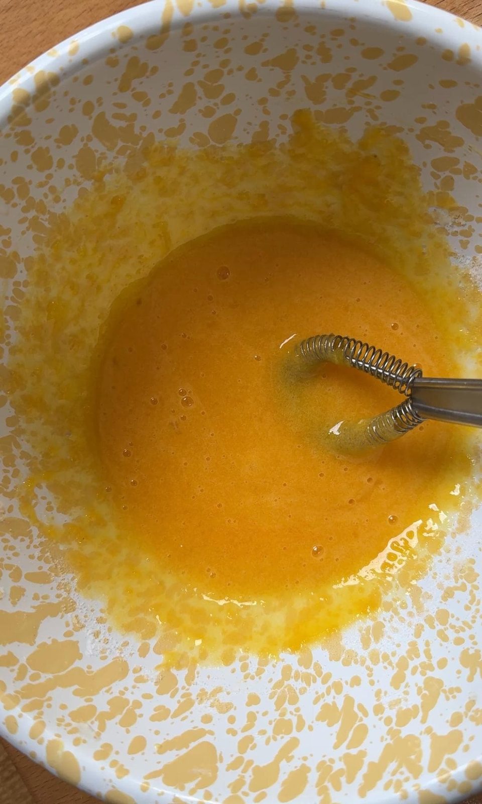 whisking egg yolks and sugar.