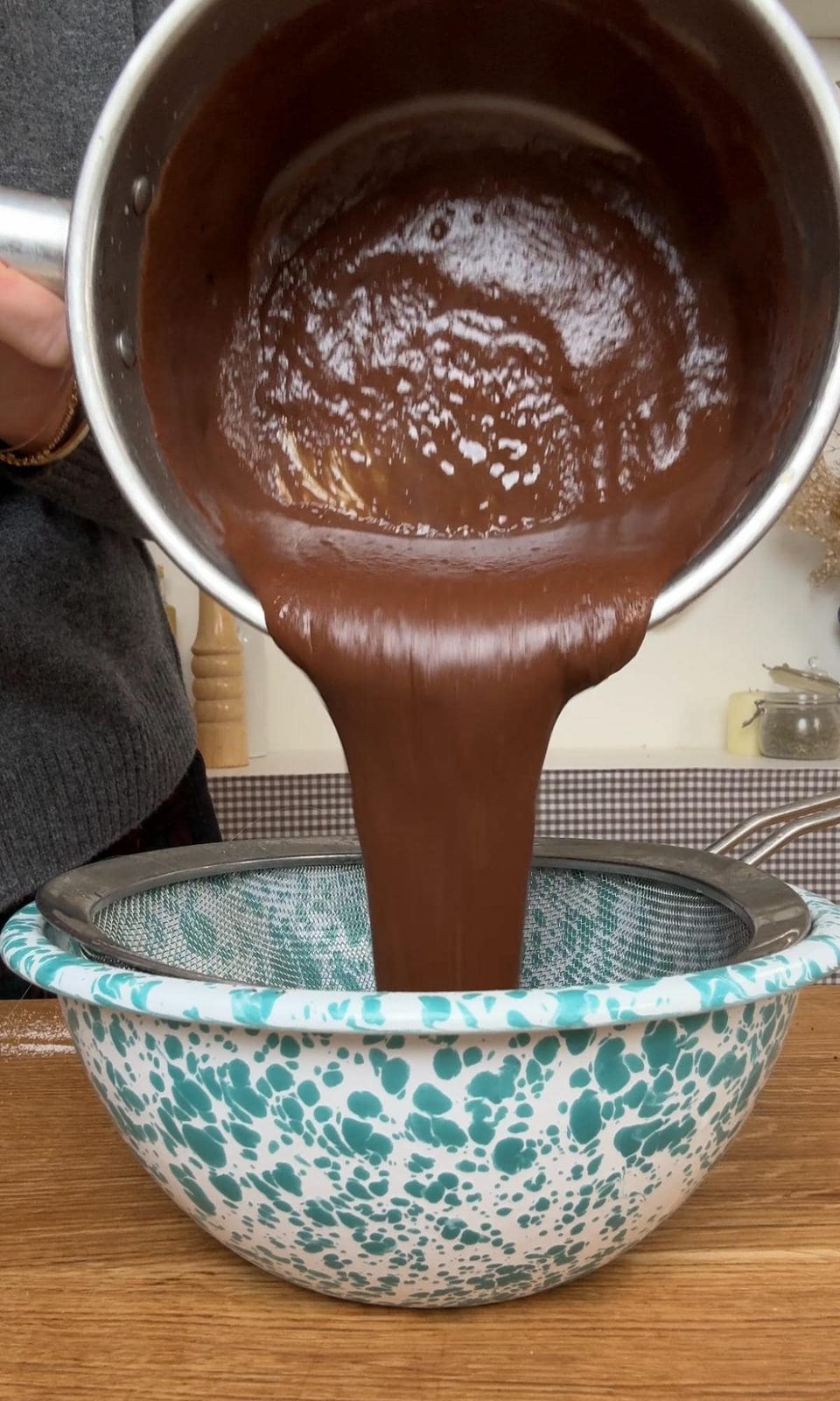 straining budino mixture through a fine sieve.