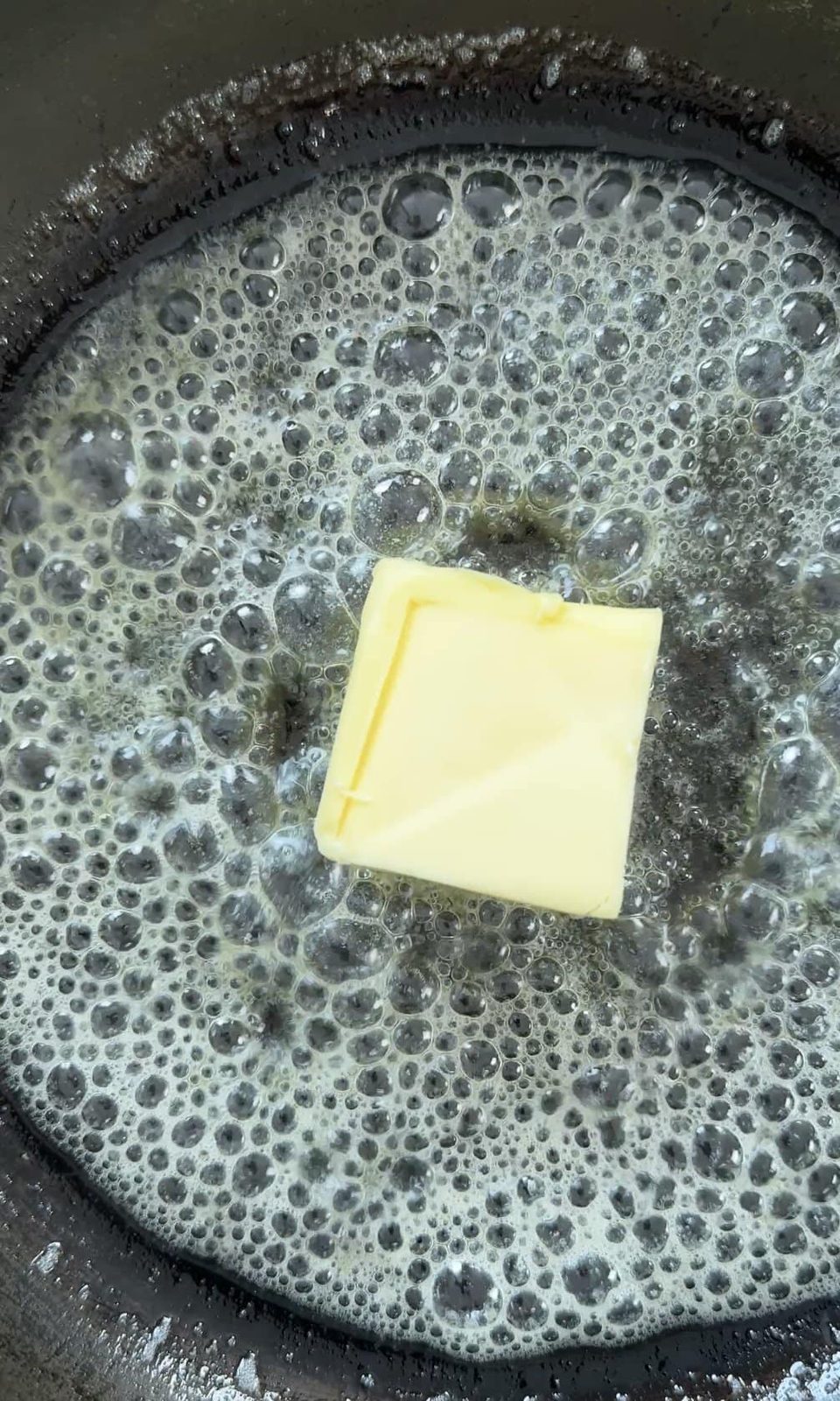 Melting butter in a pan.