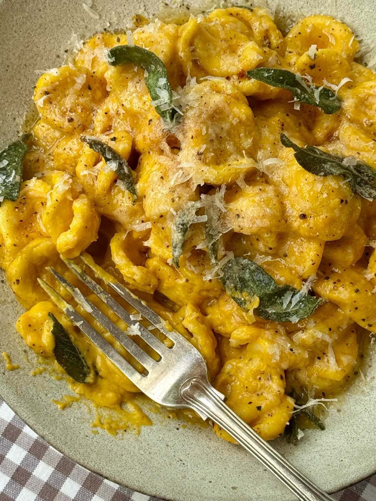 bowl of butternut pasta with crispy sage on top.