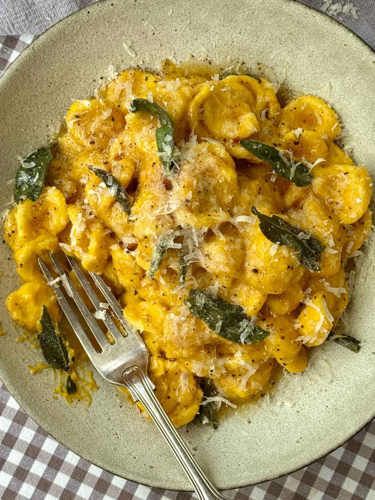 bowl of butternut pasta with crispy sage on top.