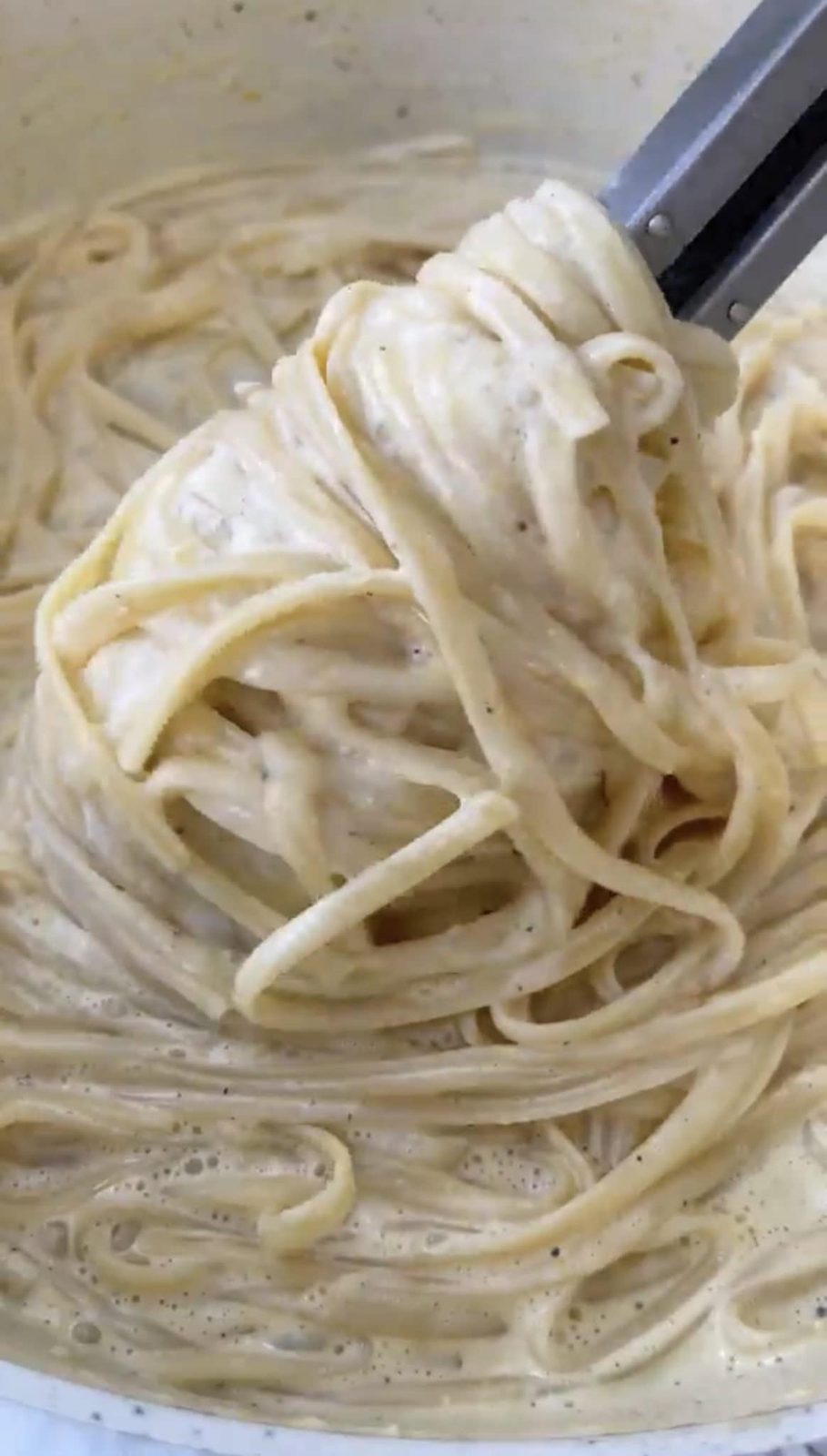 Mixing together the buttery lemon pasta