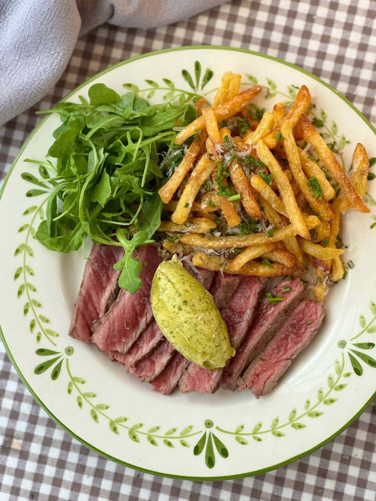 a scoop of cafe de paris butter on steak with chips.