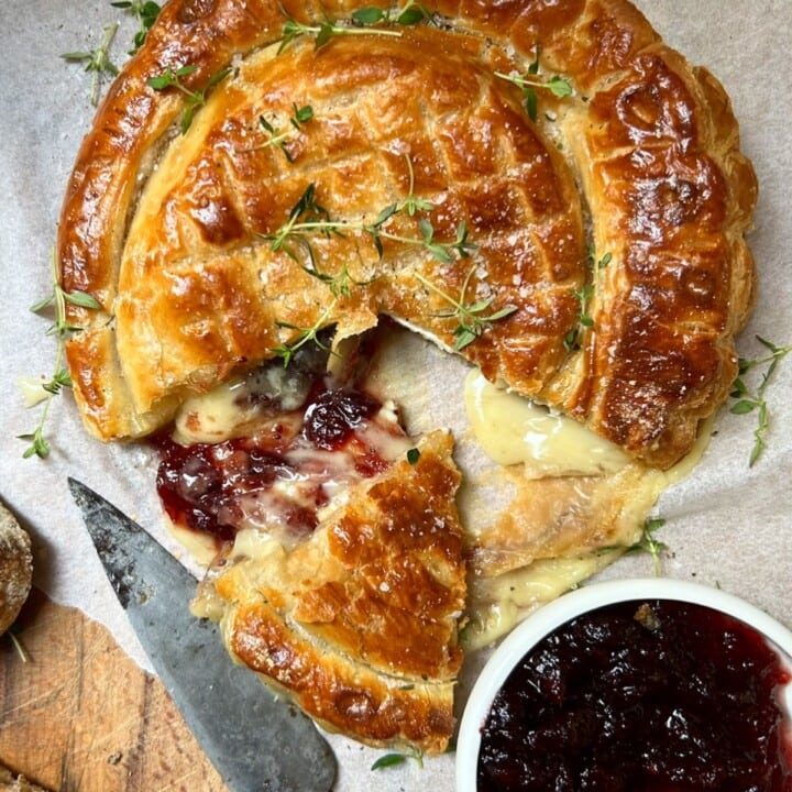 Slicing the Camembert en Croute (Whole Baked Camembert in Puff Pastry).