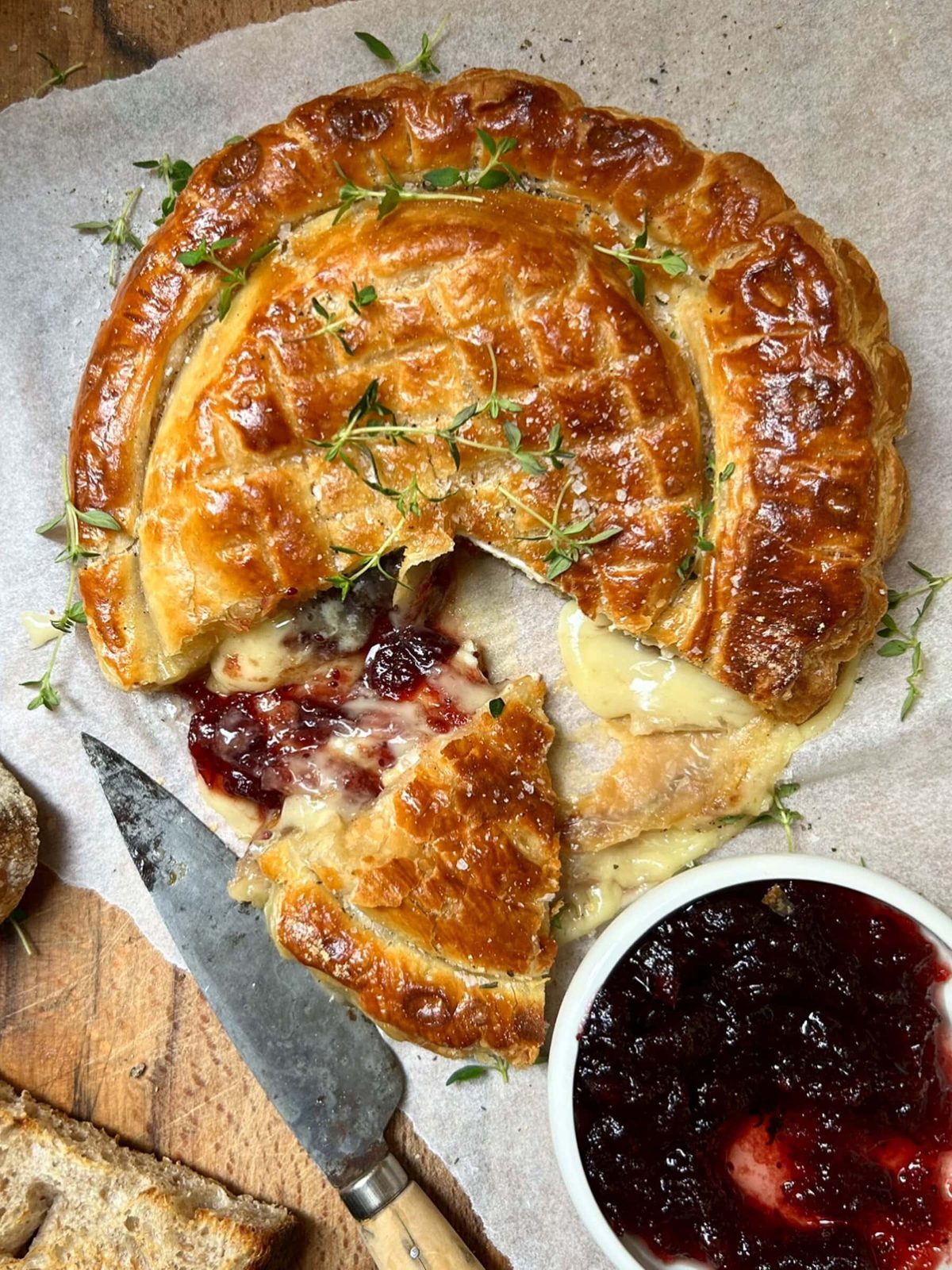 Slicing the Camembert en Croute (Whole Baked Camembert in Puff Pastry).