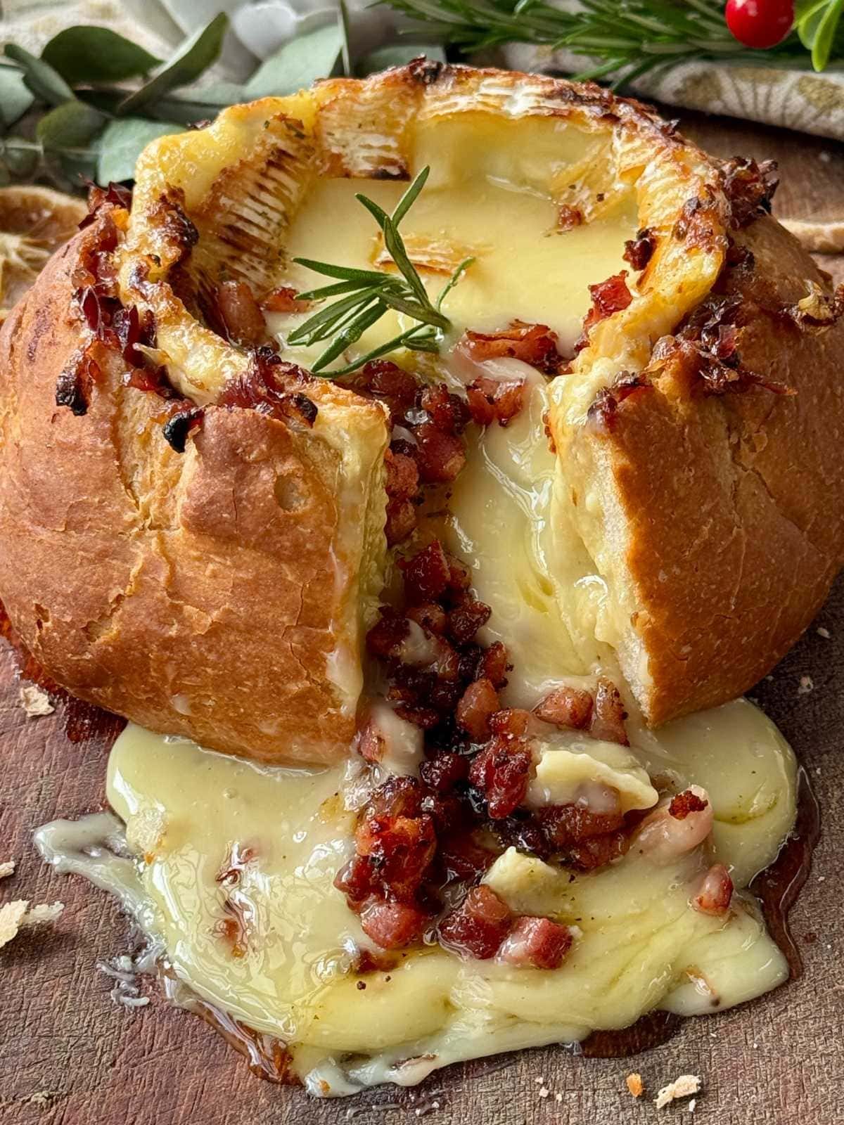 Camembert roti in a loaf of bread.