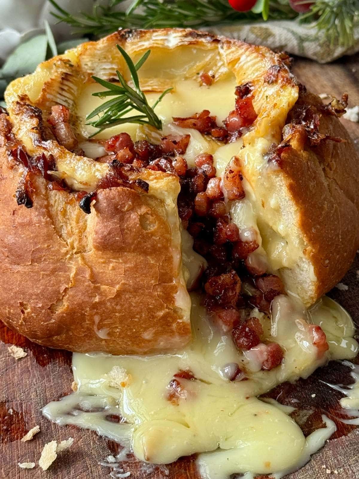 Camembert roti in a loaf of bread.