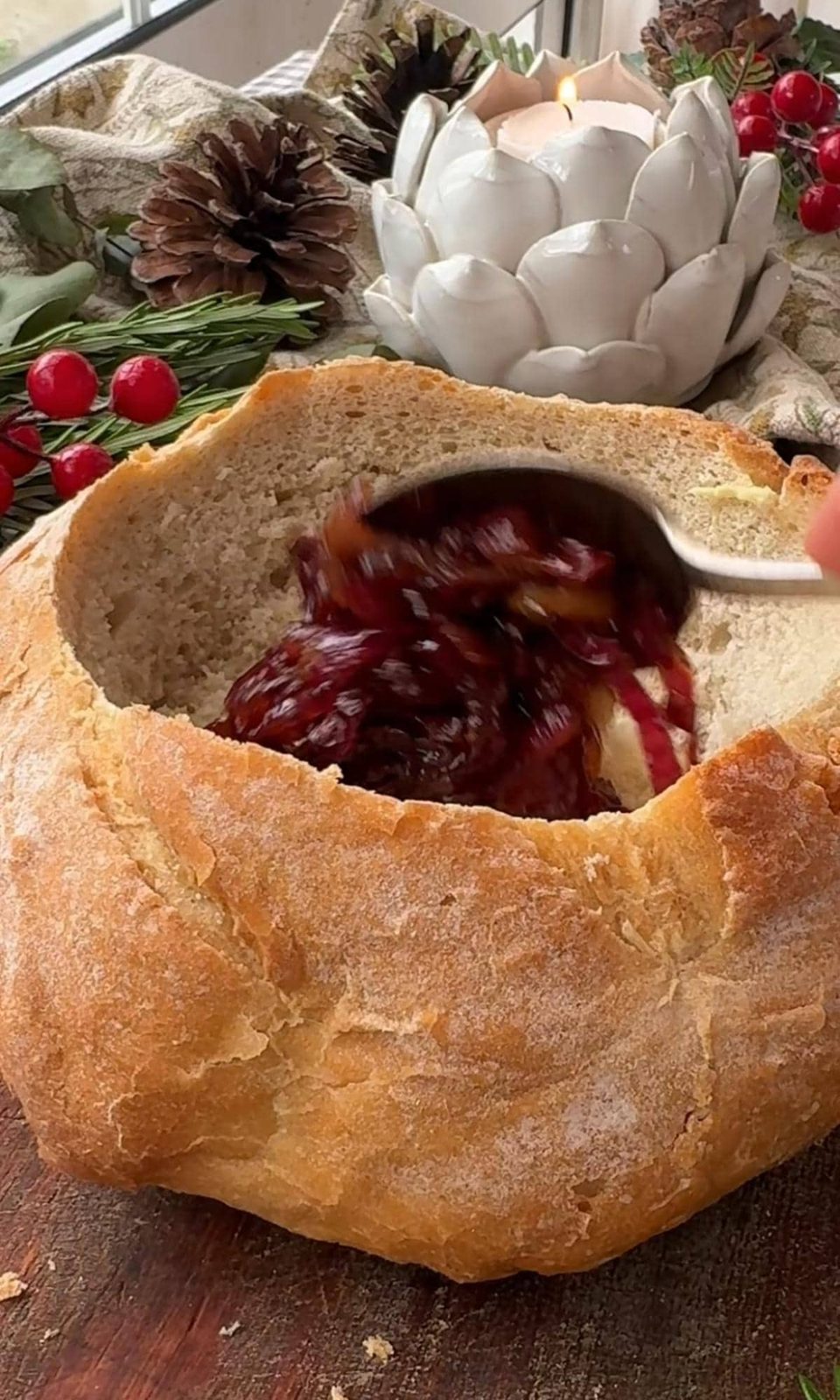 Adding caramelized red onions to the hollow loaf of bread.