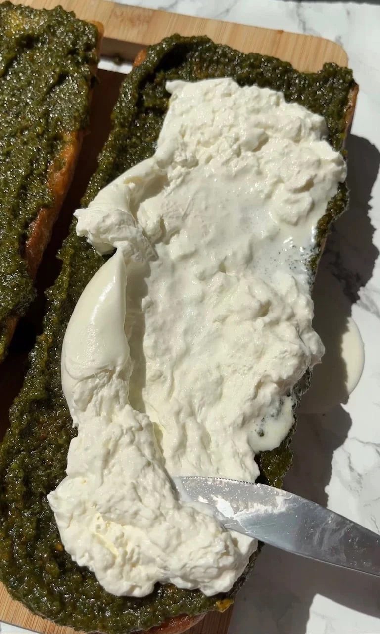 smoothing burrata on pesto.