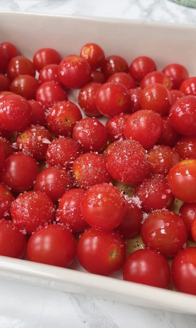adding salt to cherry tomatoes.