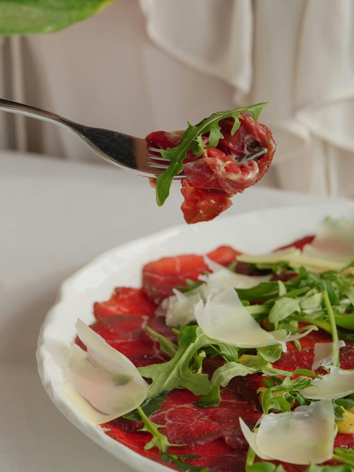 beef carpaccio on a fork.