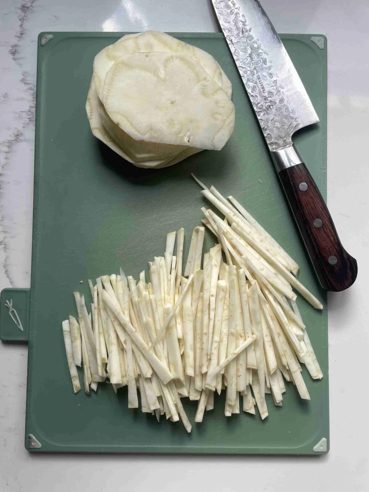 slicing celeriac into matchsticks.