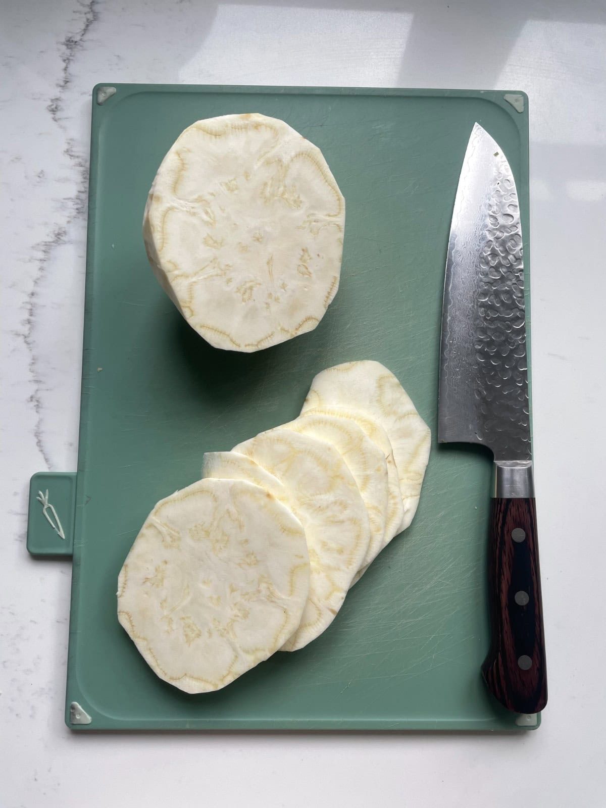 slicing celeriac into thin discs.