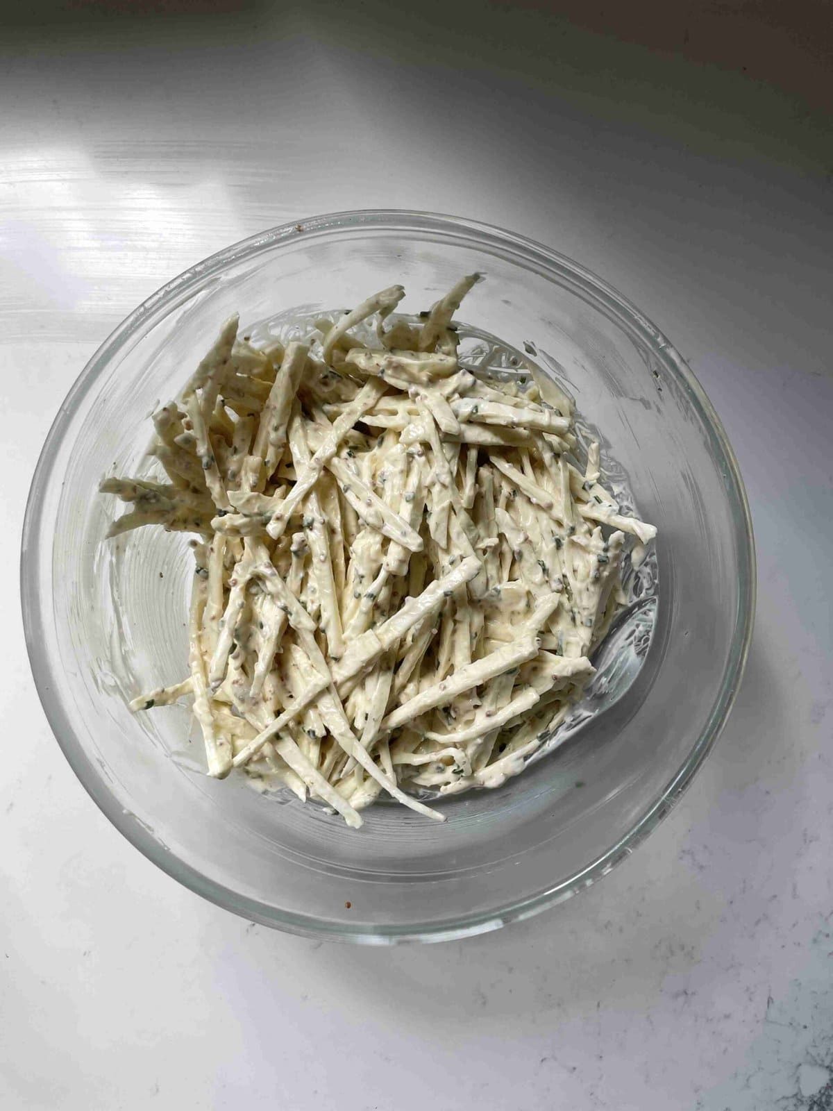celeri remoulade in a glass bowl.