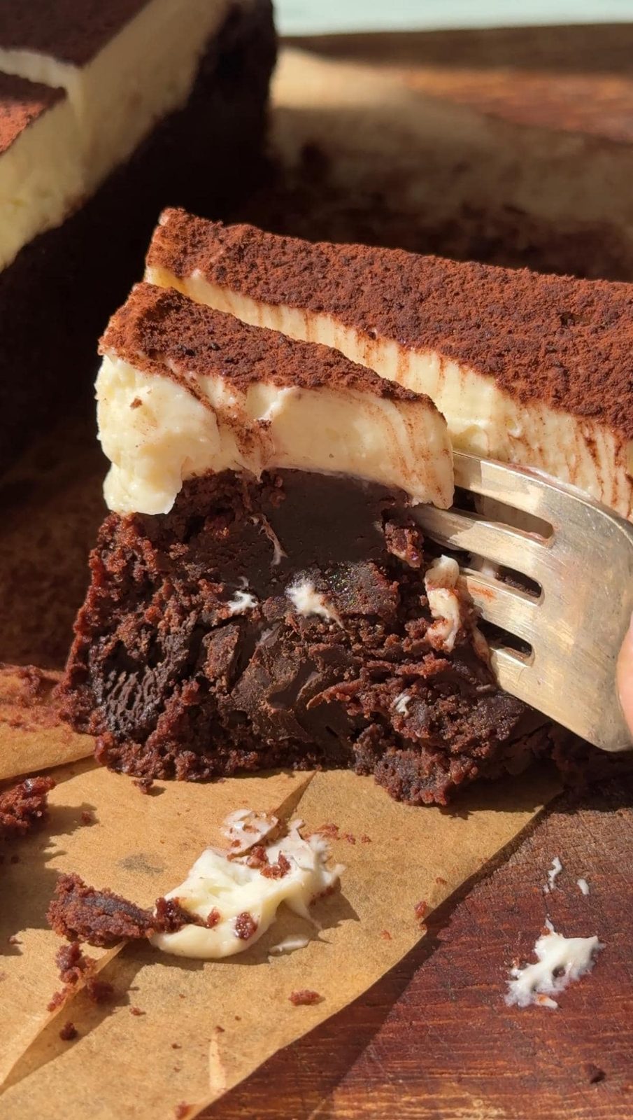 fork cutting through cheesecake brownie.