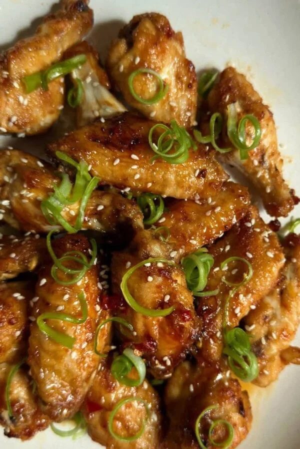 Hot Honey Chicken wings on a white plate.