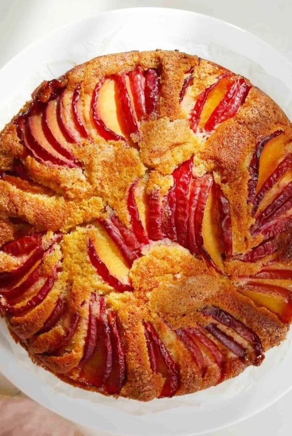 Plum yogurt cake on a white plate.