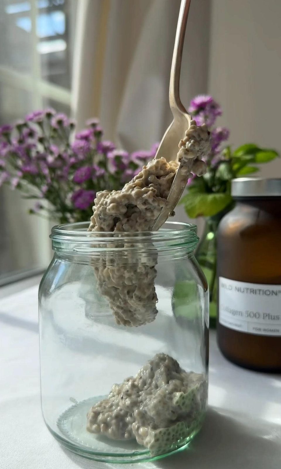 spooning the chia pudding into jars.