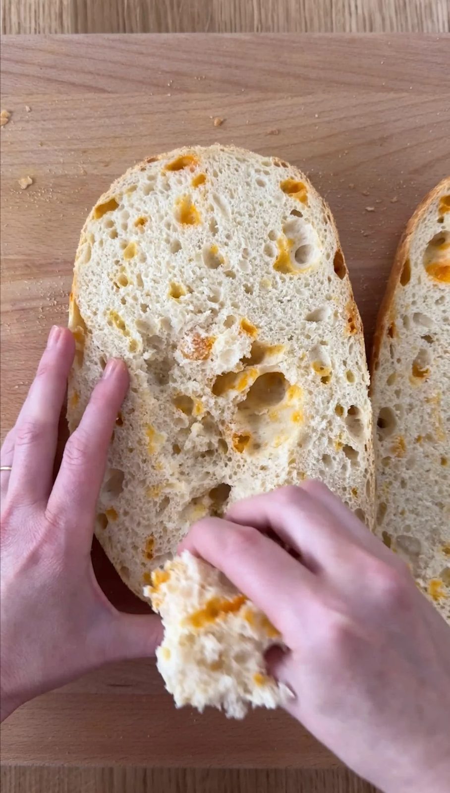 Woman picking out middle of bread to make breadcrumbs